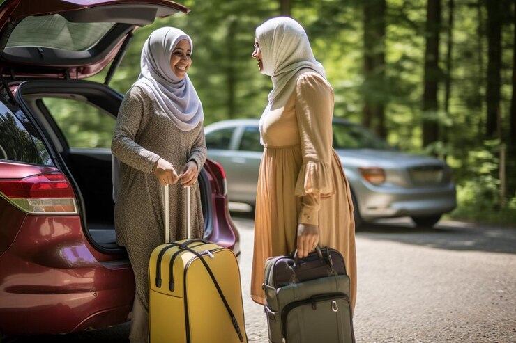 muslim women with hijabs taking their luggage out cars trunk while being vacation_1106939 129132